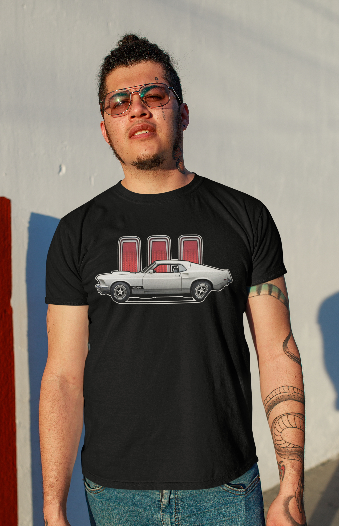 Image of A man wearing a Ford Mustang tshirt by a wall.