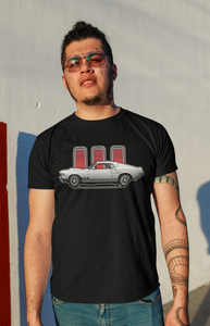 A man wearing a Ford Mustang tshirt by a wall.