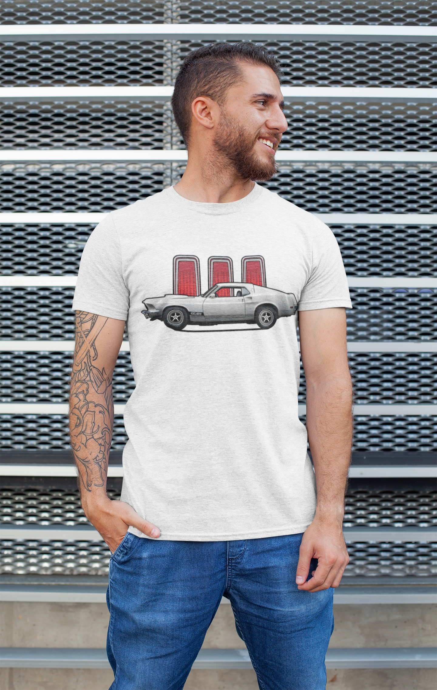 Image of A man wearing a white Ford Mustang tee shirt by a wall.