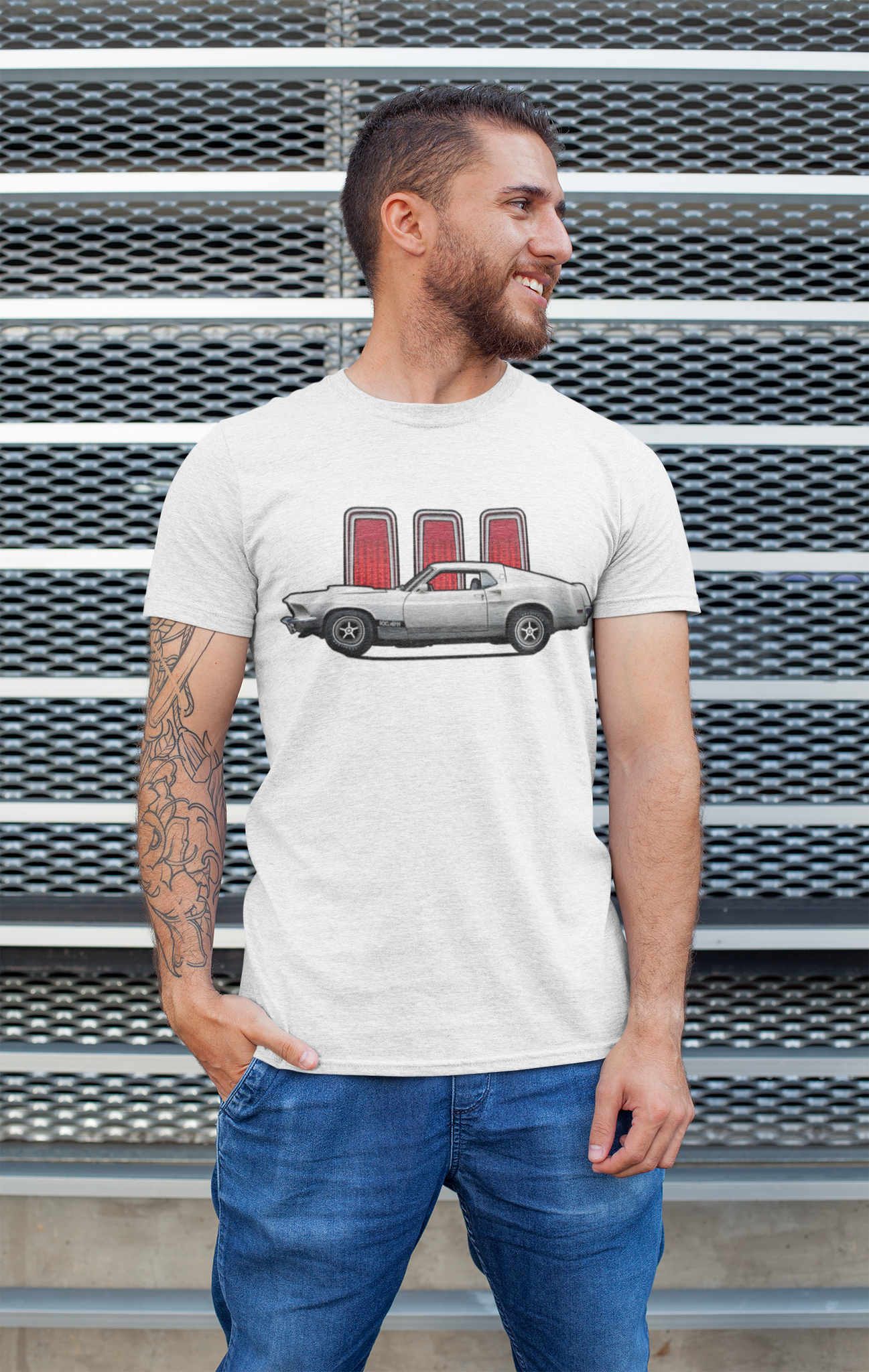 A man wearing a white Ford Mustang tee shirt by a wall.