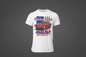 A white tee shirt with the image of a Mustang muscle car. The shirt has text that reads "American Made, World Class".