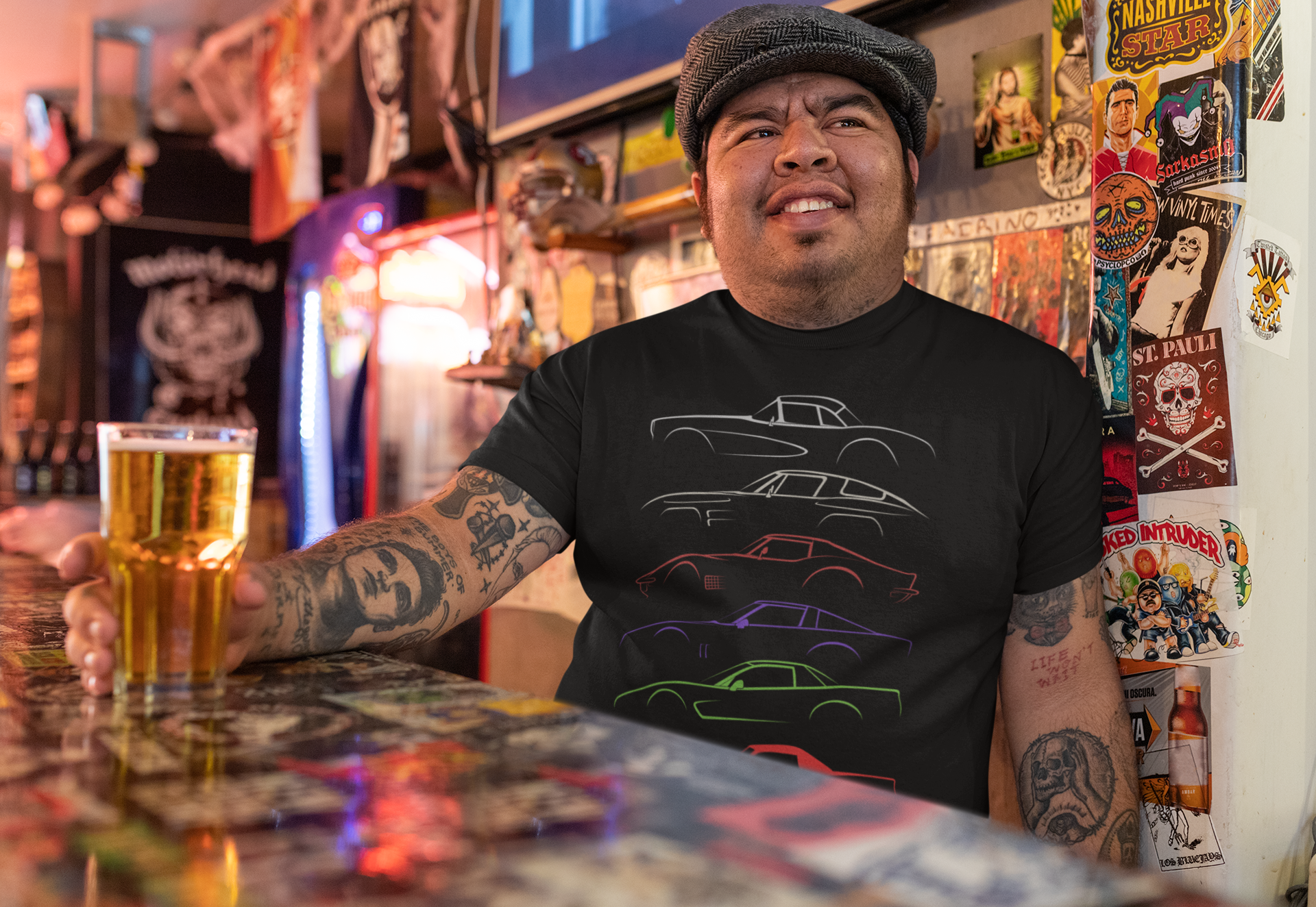 Image of A man sitting in a colorful bar, wearing a Corvette tee-shirt, made by 100mph.