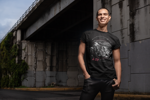 A man by a bridge, wearing a tee-shirt with a Chevy LS1 engine printed on the front. Made by 100mph