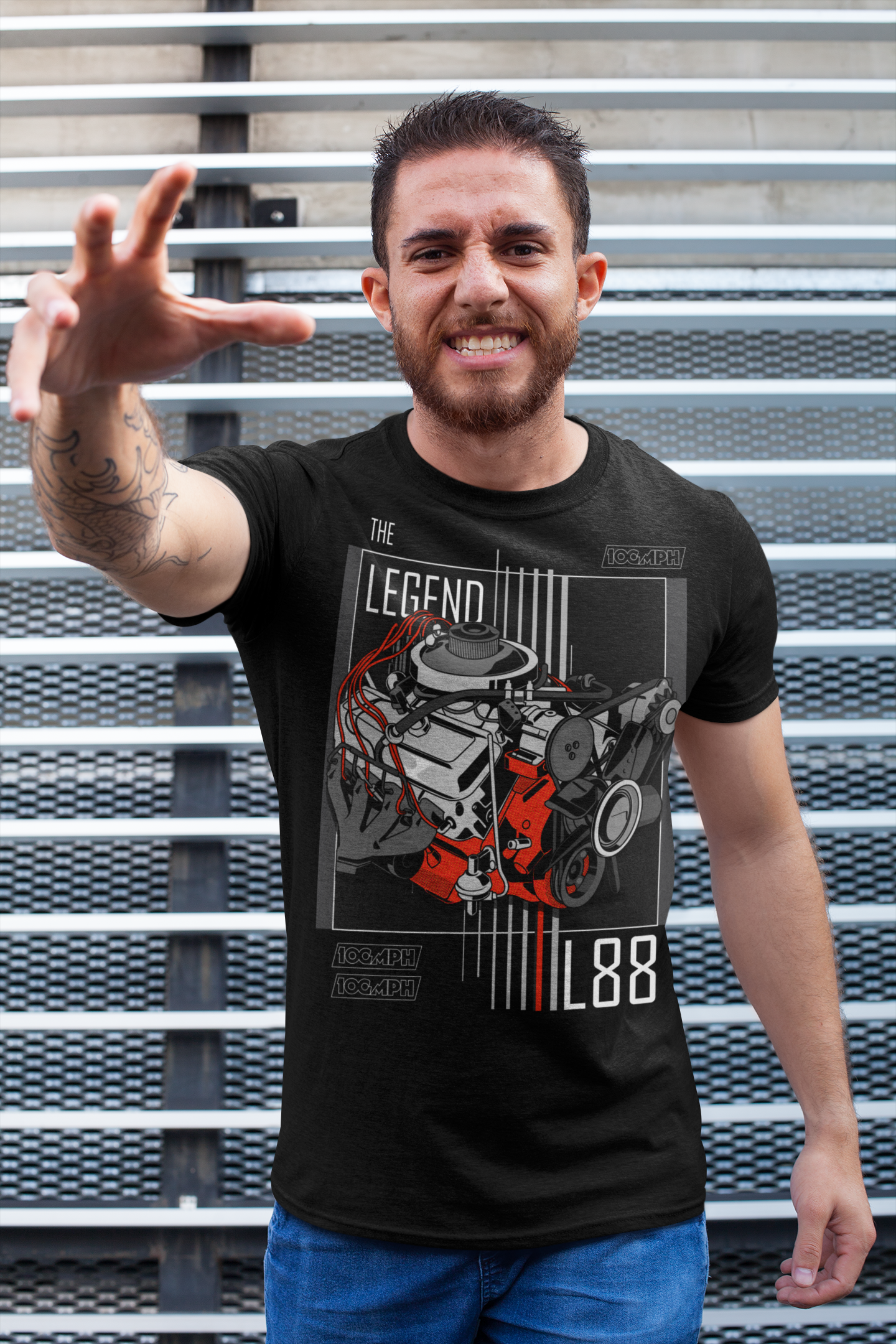 A tall man wearing a tee-shirt with a Chevy L88 engine printed on the front. Made by 100mph