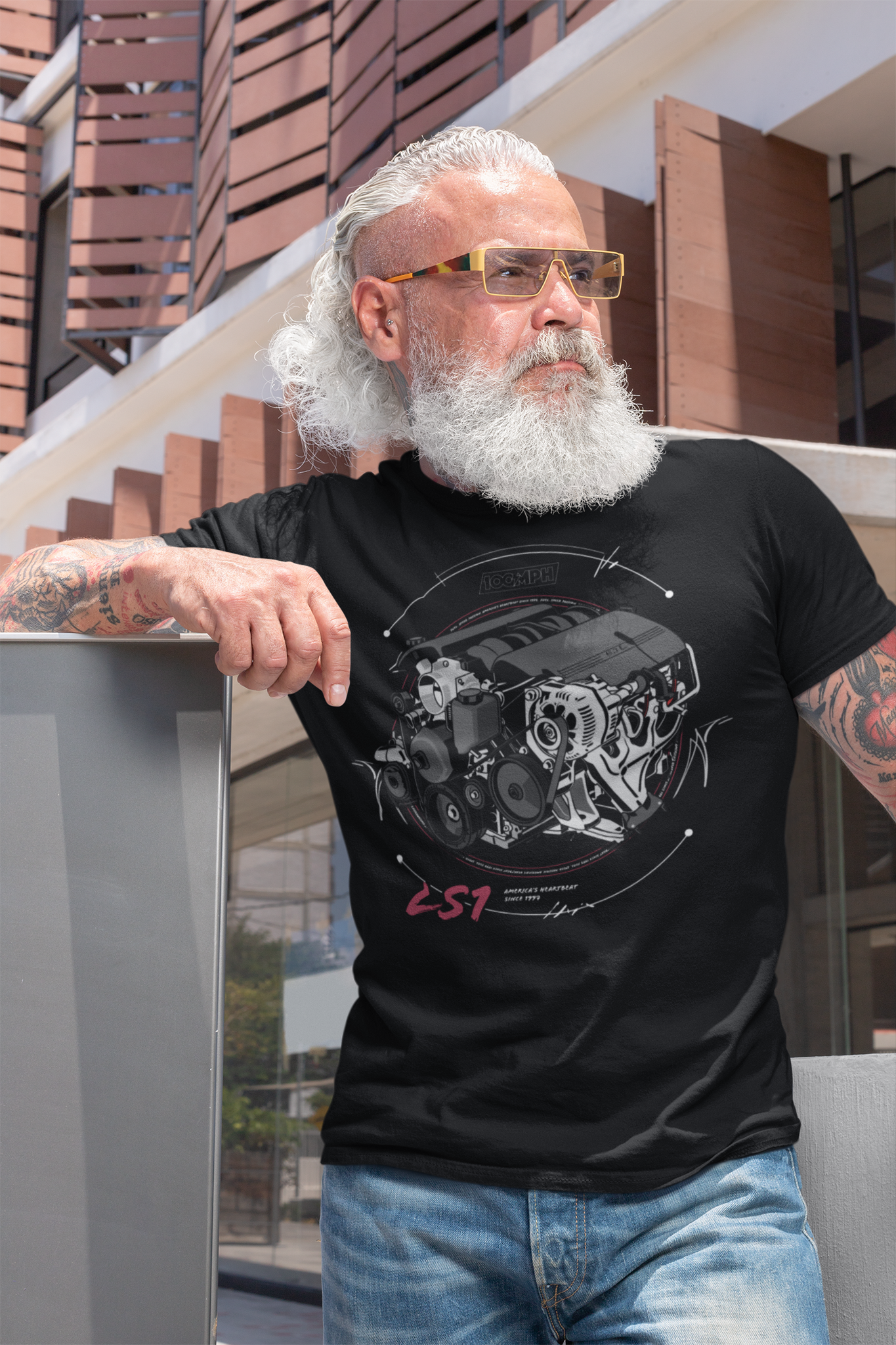 A bearded man, wearing a tee-shirt with a Chevy LS1 engine printed on the front. Made by 100mph